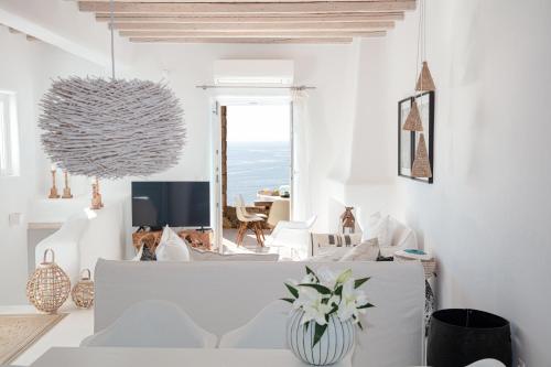米克诺斯城Villa Mandala的客厅配有白色家具,享有海景。