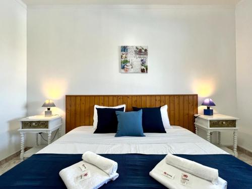 塔维拉Tavira Vila Formosa 3 With Pool by Homing的一间卧室配有一张带2个床头柜的大床