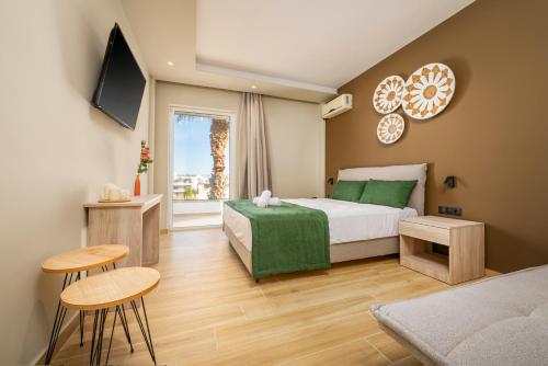 卡尔扎迈纳Nicolas Grand Suites, Adults Only的卧室配有一张床和一张桌子及椅子