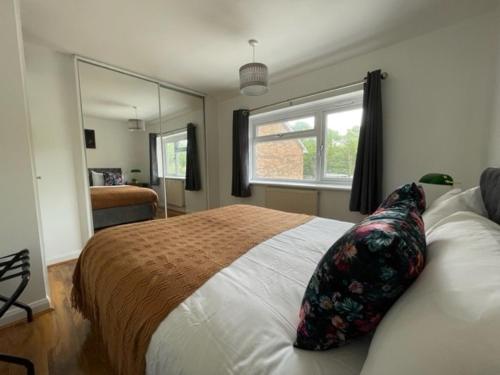 巴塞尔顿Stylish 3 bedroom House In Grt Gregorie Basildon & Essex - Free Wifi, Parking, Dedicated Office & Private Garden的一间卧室设有一张大床和一个窗户。