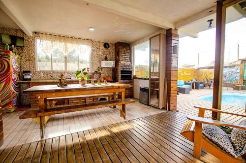 普腊亚罗萨Hostel Quintal do Rosa的客厅设有桌子和游泳池
