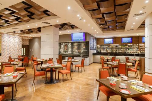 墨西哥城墨西哥佩德雷加尔卡米奥真实酒店的一间带桌椅的餐厅和一间酒吧