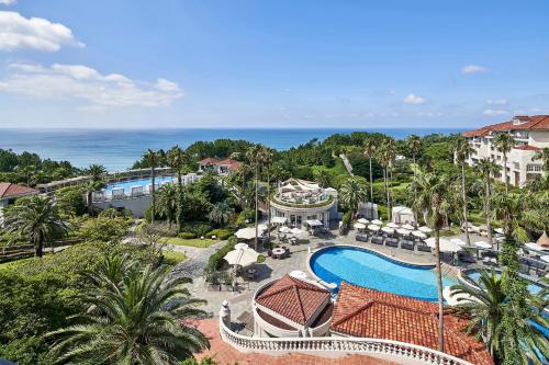 西归浦市济州岛新罗酒店的享有带游泳池的度假村的空中景致