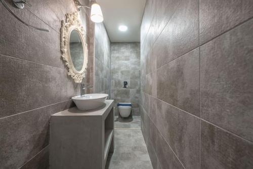 雅典Veni Central View 2Bdr Apt的一间带水槽、镜子和卫生间的浴室
