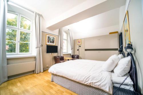 斯德哥尔摩拉格霍尔门酒店的卧室配有白色的床和2扇窗户。