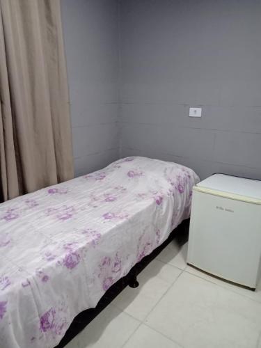 PinhaisPousada vithoria的小卧室配有一张带粉色毯子的床