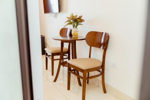 河内Vĩnh Sơn Nội Bài的一张桌子,两把椅子,一张桌子,上面有植物