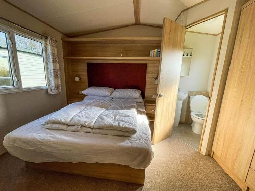 大雅茅斯6 Berth Caravan At California Cliffs With Decking In Scratby Ref 50015kc的一间卧室设有一张床和一个卫生间。