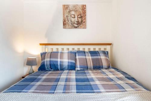 贝尔法斯特Close to city centre home的一张带枕头的床和墙上的照片