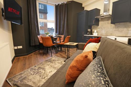 滨海索尔特本Black Pearl Stays - Saltburn Apartments的客厅配有沙发和桌子