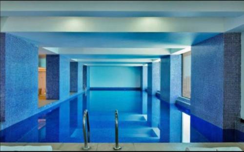 达累斯萨拉姆RB studio apartment with free Wi-Fi的一座拥有蓝色墙壁和天花板的大型游泳池
