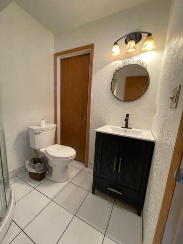 南福克云杉旅馆的一间带卫生间、水槽和镜子的浴室