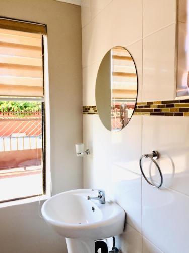 MogwaseMeLeano Guesthouse的白色的浴室设有水槽和镜子