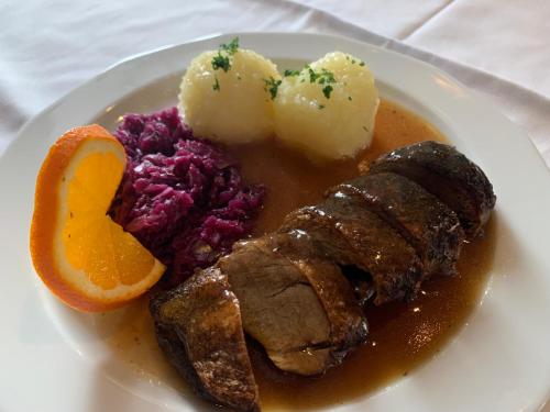 RinglebenLandgasthof Zum Ring的一块肉、土豆和橙片的食物