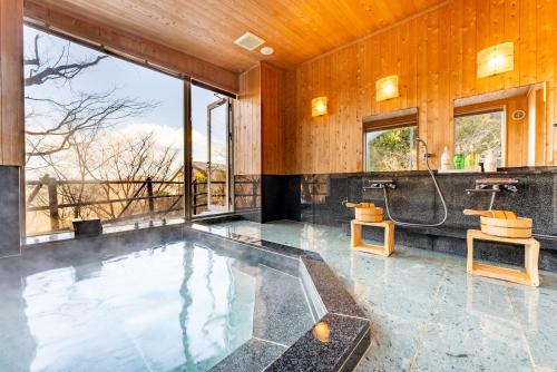 箱根Noёl HAKONE GENSEN的大型浴室设有浴缸和淋浴。