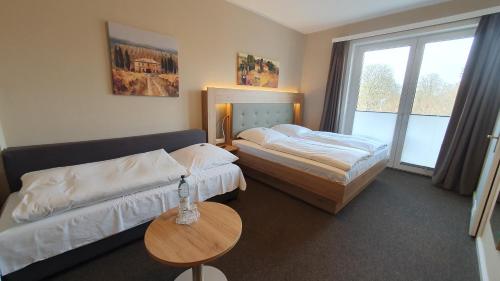 哈默尔恩阿特斯达特酒店的酒店客房设有两张床和一张桌子。
