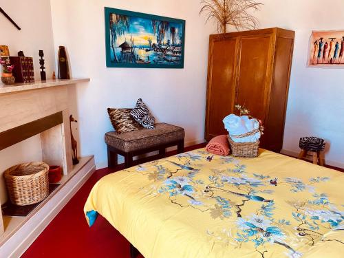 圣焦万尼泰亚蒂诺阿尔沃洛住宿加早餐旅馆的一间卧室配有一张床、一把椅子和一个壁炉