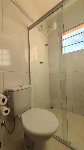 瓜拉廷格塔Pousada São José的一间带卫生间和玻璃淋浴间的浴室