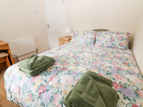 波弗特Sweeney's Cottage的一间卧室配有一张带花卉床罩的床