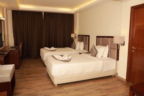 柴瑞海滩Paravoor Galaxy Hotel的酒店客房配有两张床和一张书桌