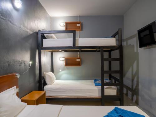 甲米镇Leisure Hostel的双层床间设有两张双层床和梯子