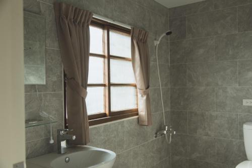 鴉埠客棧x南華大旅社的一间带卫生间、窗户和水槽的浴室