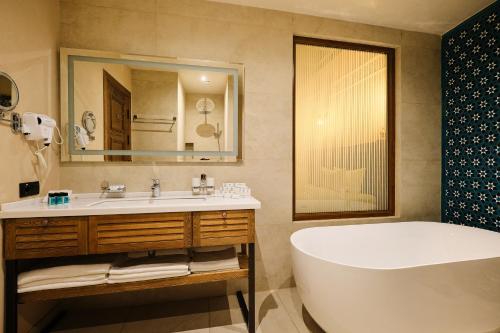 撒马尔罕Kosh Havuz boutique hotel的带浴缸和盥洗盆的浴室