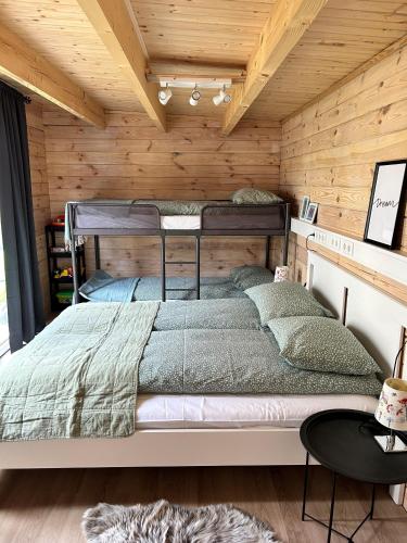 凯夫拉维克The Little Guesthouse Downtown - Keflavik Airport的卧室配有木墙内的一张床