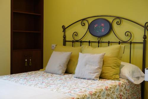 卢安科ALMAR, Apartamento en Luanco.的一间卧室配有一张带金属床头板和枕头的床。