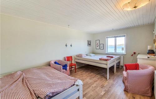特罗尔海坦Lovely Home In Trollhttan With House Sea View的一间卧室设有两张床和窗户。