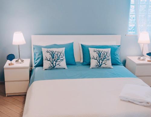 圣泰雷萨迪里瓦Le sorelle的一间卧室配有一张带蓝色和白色枕头的床
