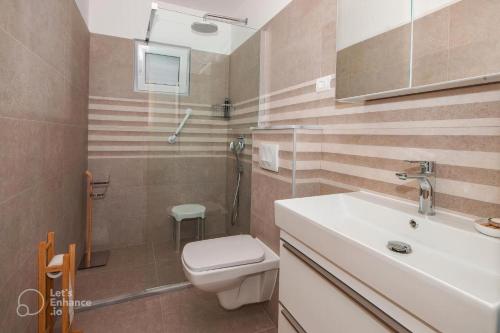 奥库格哥恩基Apartment Marina的浴室配有卫生间、盥洗盆和淋浴。