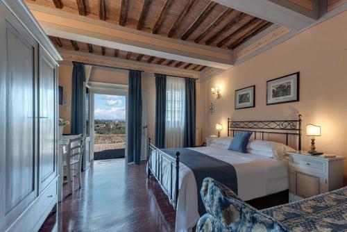 锡耶纳迪瓦里宫酒店的一间卧室设有一张床和一个大窗户