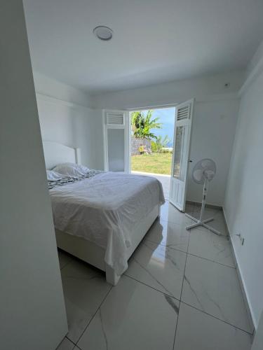 旧阿比唐Villa C的白色的卧室设有床和窗户