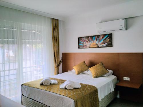 戈西克Ada Apart Hotel Göcek的酒店客房,配有带毛巾的床