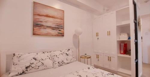 巴科洛德Ecostay @ Amaia的卧室配有一张床,墙上挂有绘画作品
