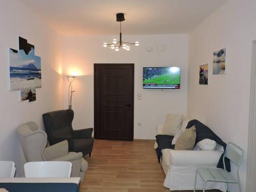 卡尔帕索斯Annissa Appartment的客厅配有两张沙发和一台电视机