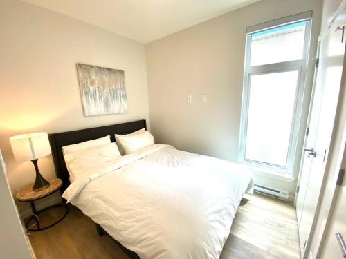 悉尼Lovely Brand New Suite的卧室配有白色的床和窗户。