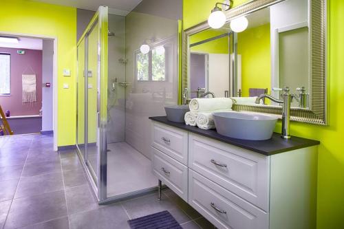 奥朗日La maison des Eucalyptus - Piscine, jacuzzis et lac的一间带两个盥洗盆和淋浴的浴室