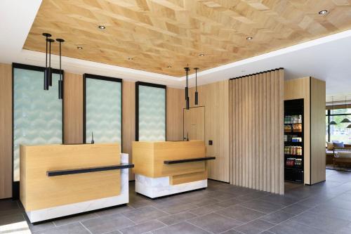 NaganumaFairfield by Marriott Hokkaido Naganuma的厨房配有木制橱柜和带窗户的天花板。