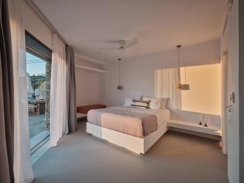 KrotiriOlithos Villas的一间白色卧室,配有床和阳台