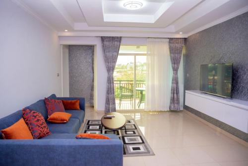 基加利Grazia Apartments的客厅配有蓝色的沙发和电视