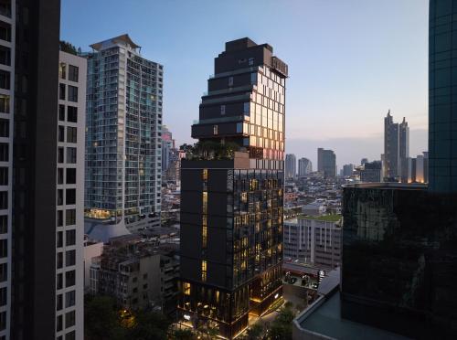 曼谷dusitD2 Samyan Bangkok的一座高大的建筑,城市里灯火通明