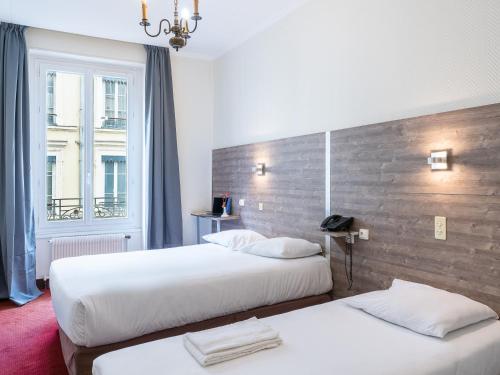 里昂埃尔德酒店的酒店客房设有两张床和窗户。