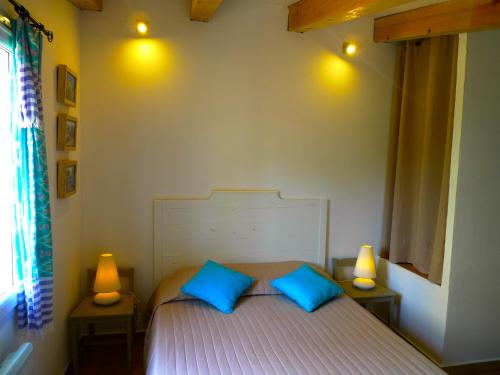 科尔巴拉A ChiOsella的一间卧室配有一张带两个蓝色枕头的床