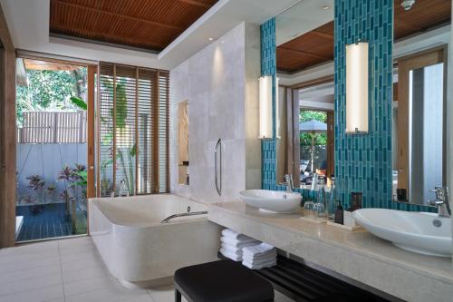 迈考海滩普吉万丽度假酒店的一间带两个盥洗盆和大镜子的浴室