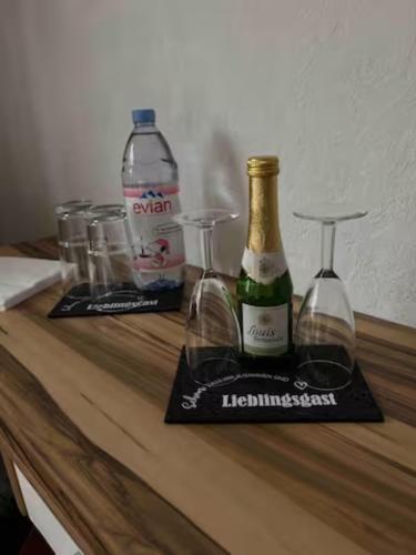 科隆Zimmer in Köln的一张桌子,上面放有两杯酒和一瓶葡萄酒