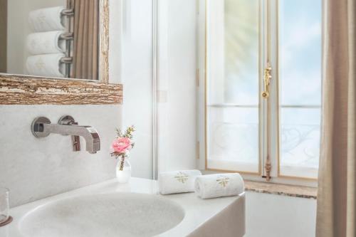科涅克La Nauve, Hôtel & Jardin - Relais & Châteaux的白色的浴室设有水槽和镜子