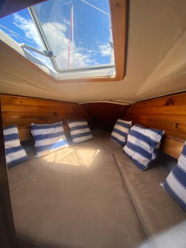 巴塞罗那Boat Barcelona Yacht的一间设有枕头和船窗的房间