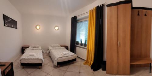 波兹南Miastkovo的小房间设有两张床和窗户